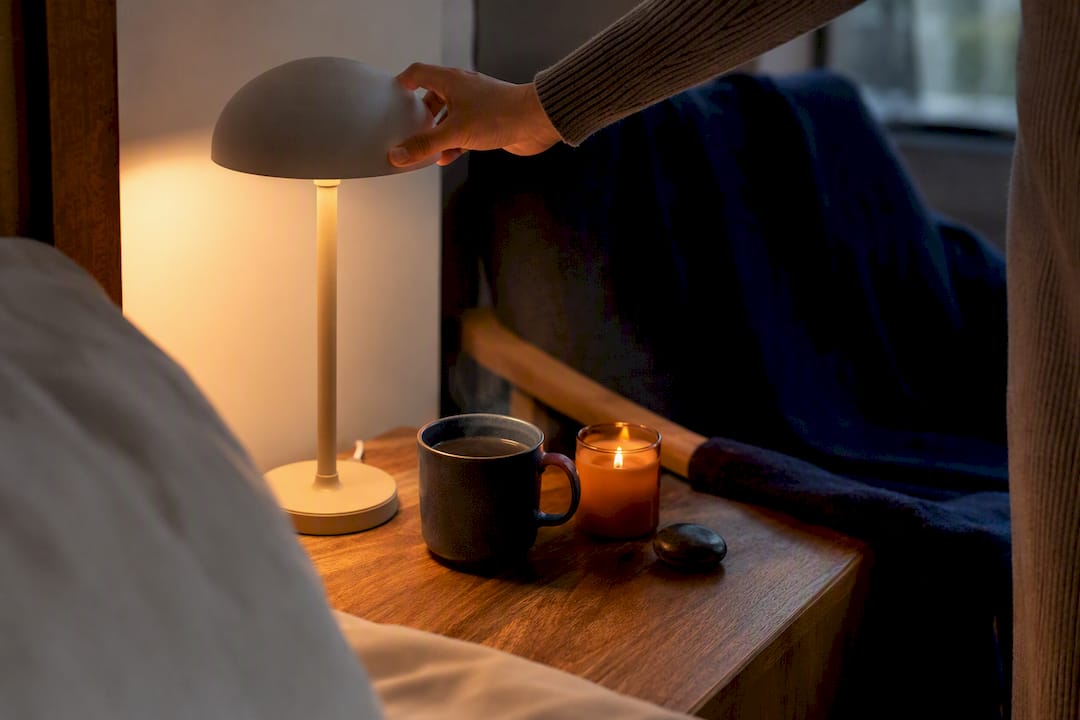 Hand turning off lamp for bedtime wind-down