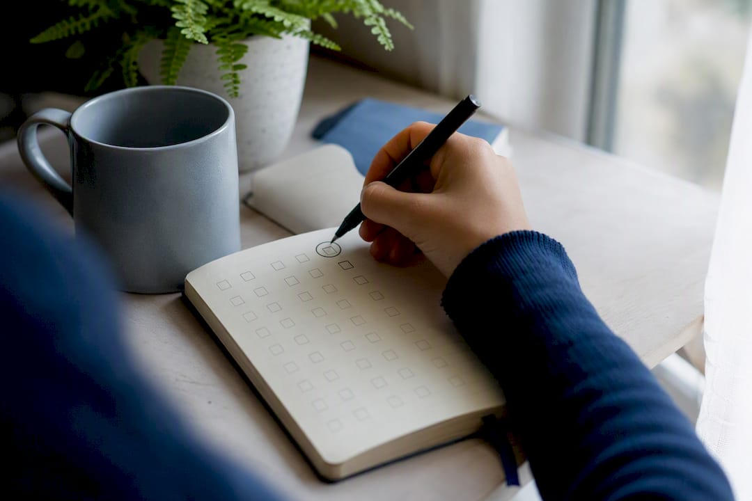Hand checking habit tracker box