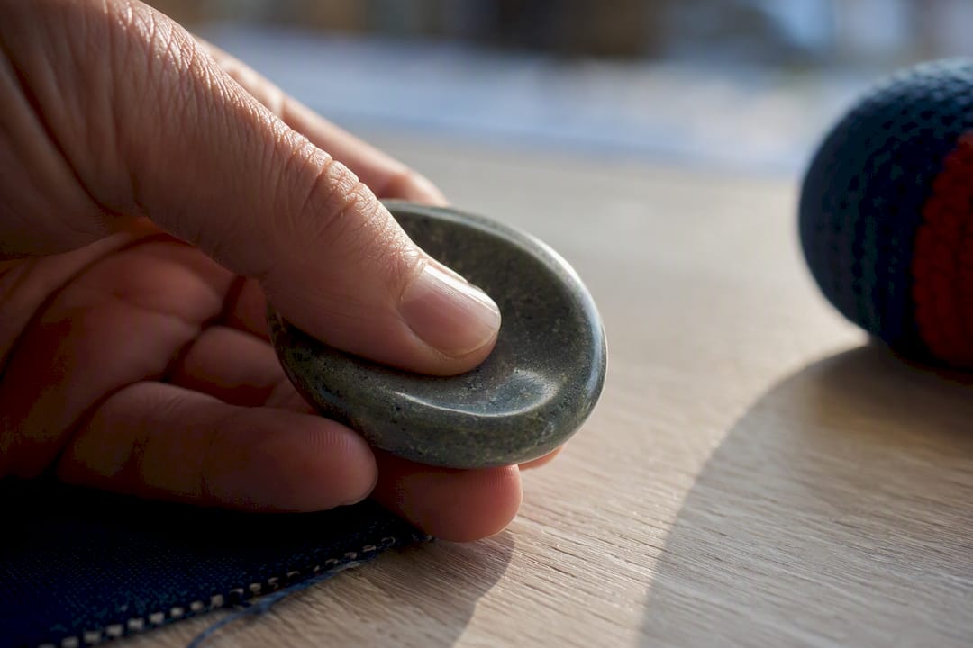 Thumb tracing a worry stone groove
